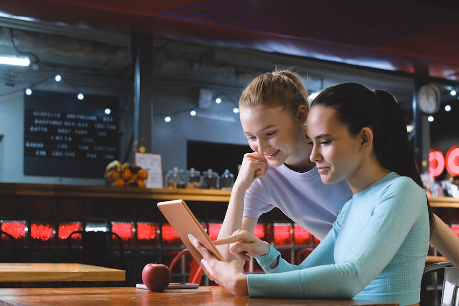 A person thoughtfully browsing course options on a clean, modern website interface on a tablet.